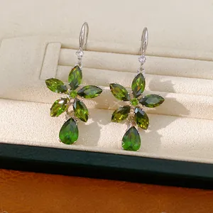 Elegant olive green zircon flower drop earrings showcased in a luxury jewelry display box