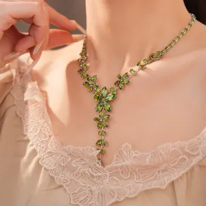 Macro view of an exquisite green zircon floral necklace showing intricate petal details