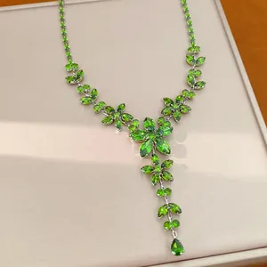 Detailed view of an elegant green zircon flower necklace with delicate water-drop pendants