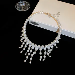 Elegant French style pearl fringe choker necklace detail with hanging pearl tassels.