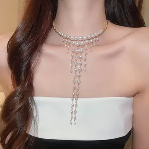 Elegant French palace style pearl tassel choker necklace worn by a female model
