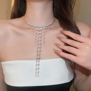Detail view of an elegant French palace style pearl tassel choker on an Asian model.