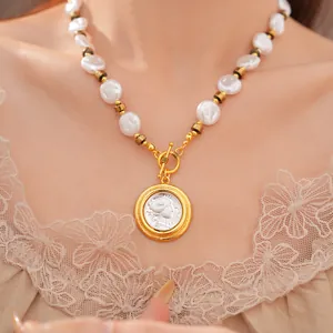 Close-up detail of a vintage style pearl necklace with an embossed portrait coin pendant