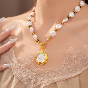 Elegant close-up of a vintage pearl necklace with a gold cameo pendant