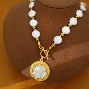 Detailed close-up of a vintage pearl necklace featuring a golden coin portrait pendant