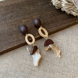 Detailed macro view of New Chinese vintage earrings featuring wood beads and shell dangles