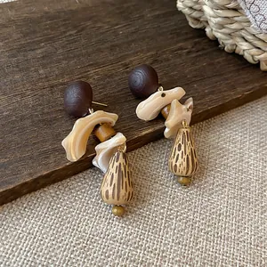 Handcrafted vintage shell and wood pendant earrings with New Chinese style aesthetics