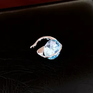 Elegant silver-tone ear cuff featuring a large brilliant-cut blue oval zircon gem