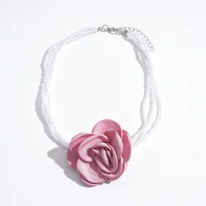 Elegant multi-layer white pearl necklace featuring a large pink fabric rose pendant for women.