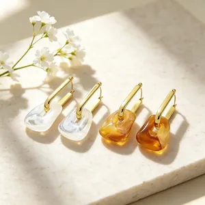 Elegant geometric gold-plated hoop earrings with marbled resin charms and floral accents
