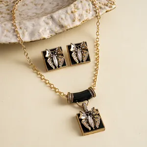 Elegant vintage gold-tone butterfly necklace and earrings jewelry set with rhinestones