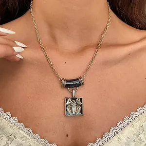 Vintage butterfly pendant necklace with rhinestones and black enamel detail on model