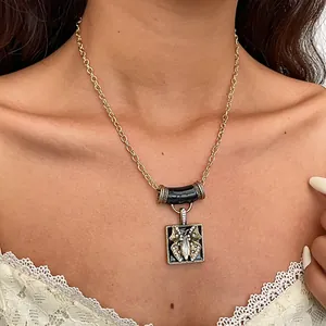 Close-up detail of a vintage butterfly pendant necklace with black enamel and rhinestones