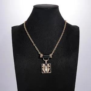 Macro detail of vintage butterfly pendant with rhinestones and black enamel finish