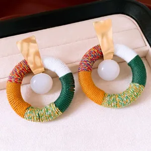 Ethnic style cotton rope wrapped hoop earrings with white resin bead and gold metal