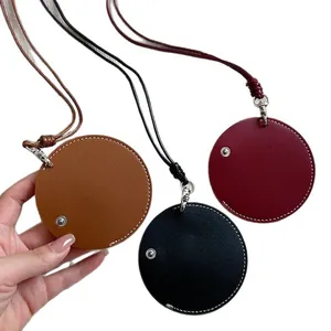 Trio of circular leather pendant necklace eyeglass holders in brown, black, and red
