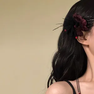 Gothic Halloween flower hair clip featuring a skeletal hand design with long black chain tassels