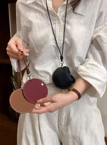 Detailed view of minimalist leather cord eyeglass clip necklaces in black, brown, and burgundy