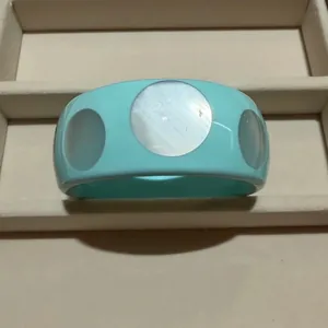Modern cyan wide bangle with large circular mother-of-pearl insets for a stylish look