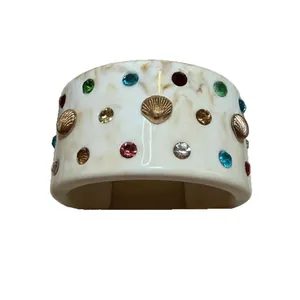 White marble-effect resin cuff bracelet adorned with colorful crystals and gold sea shells