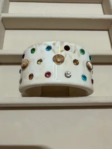 Elegant ivory marble cuff bracelet with colorful rhinestones and golden shell accents