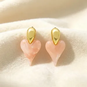 Elegant pink heart-shaped resin earrings with 18K gold plating on a soft white background