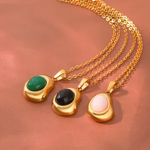 Detail of 18K gold plated stainless steel necklaces with irregular bean natural stone pendants