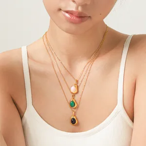Detail of 18K gold-plated stainless steel necklaces with natural stone pendants