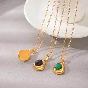 Detail of gold stainless steel necklaces with natural stone and heart pendants