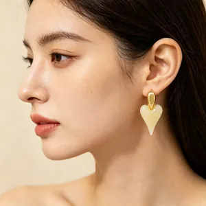Close-up of vintage heart resin earrings with 18K gold plating shown on an Asian model.