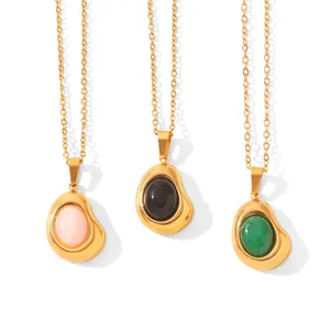 Detailed view of irregular bean-shaped 18K gold pendants with colorful natural stones