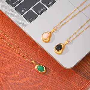 Detail view of 18K gold-plated stainless steel bean pendants with colorful natural stones