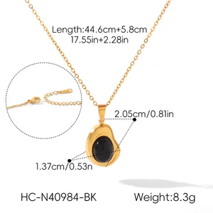 Detailed view of gold stainless steel necklace with irregular bean-shaped black stone pendant