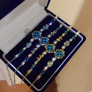 Exquisite detail of sparkling sea blue zircon flower bracelets inside a navy velvet box