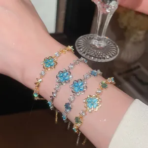 Detailed macro view of sparkling sea blue zircon flower bracelets on a lady's wrist