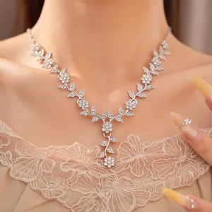 Close-up of elegant silver necklace with rhinestone leaf and flower motifs