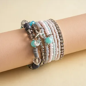 Detailed view of an 8-piece glass beaded bracelet set with a silver starfish charm