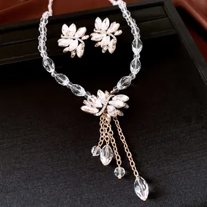 Close-up of elegant floral crystal necklace and earrings set on black velvet display