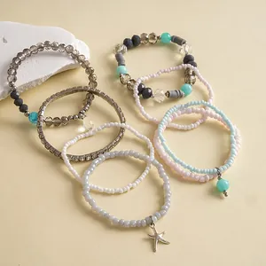 8-piece bohemian beaded bracelet set featuring glass beads and a silver starfish charm
