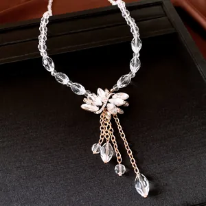 Macro view of elegant crystal floral pendant necklace with delicate gold chain dangles