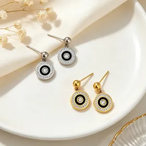 Detail view of minimalist titanium steel round earrings with pavé crystals.