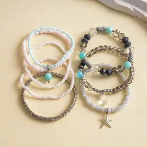 Close-up of eight-piece glass bead bracelet set with rhinestone and starfish charm