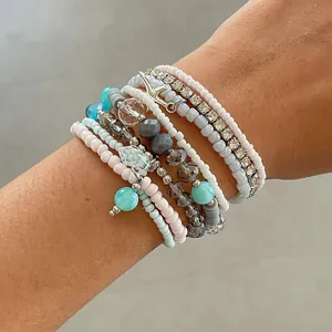 Close-up of 8pcs colorful glass beaded bracelet set with rhinestone details on wrist