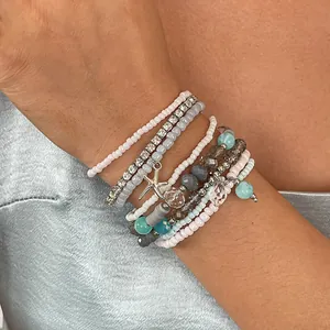 Close-up of 8-piece boho beaded bracelet set with sparkling rhinestones and a starfish charm