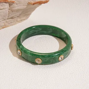 Elegant dark green marbled resin bangle with inlaid round rhinestones in gold-tone rivets