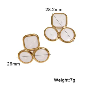 Close-up of geometric gold-plated earrings with white enamel and size dimensions.