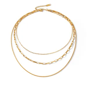 Detail of a triple layered 18K gold-plated stainless steel necklace with various chain textures.