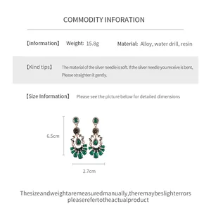 Detailed view of vintage emerald teardrop earrings with size and material specifications.