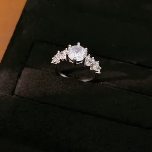 Detailansicht eines eleganten silbernen Rings mit runden Zirkonia in schwarzer Geschenkbox.