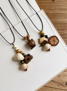 Detailed view of handmade ethnic style necklaces with wooden animal charms and beads